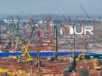 Pile driving operation takes place at the construction site of the Nanjing North Station Hub Project in Nanjing, China, on December 21, 2024...