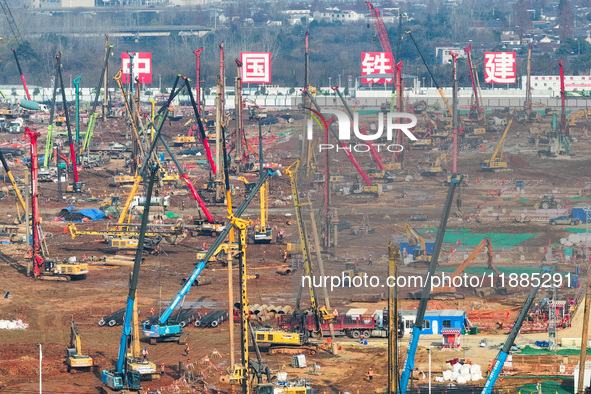 Pile driving operation takes place at the construction site of the Nanjing North Station Hub Project in Nanjing, China, on December 21, 2024...