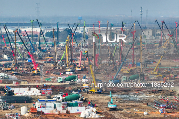 Pile driving operation takes place at the construction site of the Nanjing North Station Hub Project in Nanjing, China, on December 21, 2024...