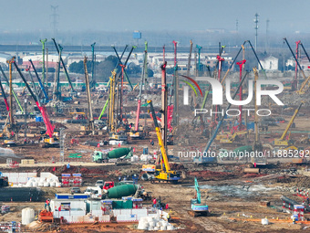 Pile driving operation takes place at the construction site of the Nanjing North Station Hub Project in Nanjing, China, on December 21, 2024...