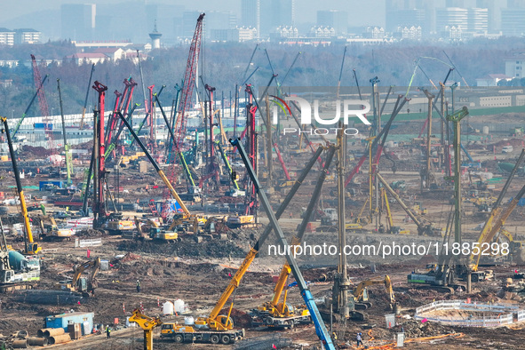 Pile driving operation takes place at the construction site of the Nanjing North Station Hub Project in Nanjing, China, on December 21, 2024...