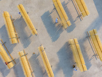 A worker places hanging noodles on a shelf to dry in Hefei, Anhui province, China, on December 21, 2024. (