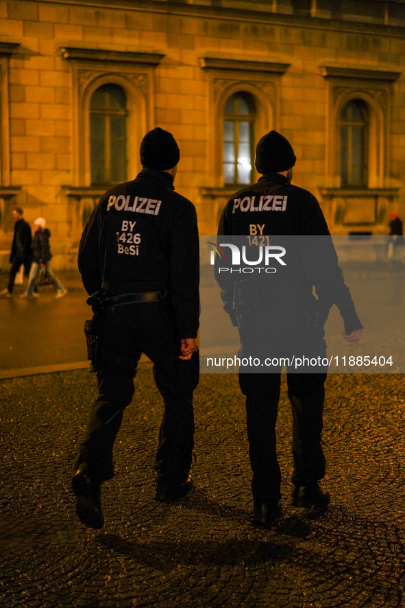 Two police officers conduct foot patrol during the evening in Munich, Bavaria, Germany, on December 20, 2024. 