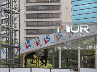 Workers complete the construction of a building's roof in Jakarta, Indonesia, on December 21, 2024. The government raises the Value Added Ta...