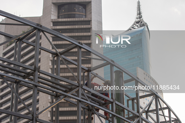 Workers complete the construction of a building's roof in Jakarta, Indonesia, on December 21, 2024. The government raises the Value Added Ta...