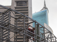 Workers complete the construction of a building's roof in Jakarta, Indonesia, on December 21, 2024. The government raises the Value Added Ta...