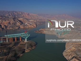 An aerial photo shows the construction of the Jianzha Yellow River Bridge, a key project of the Sichuan-Qinghai Railway in Jianzha County, Q...