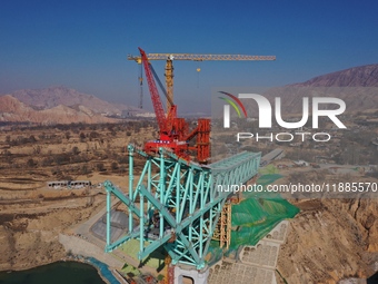 An aerial photo shows the construction of the Jianzha Yellow River Bridge, a key project of the Sichuan-Qinghai Railway in Jianzha County, Q...