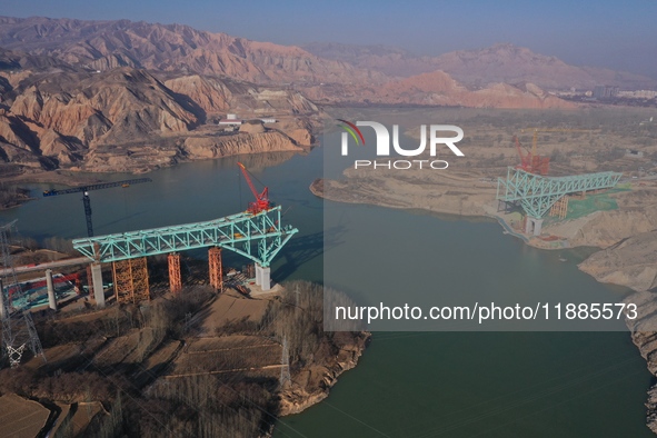 An aerial photo shows the construction of the Jianzha Yellow River Bridge, a key project of the Sichuan-Qinghai Railway in Jianzha County, Q...