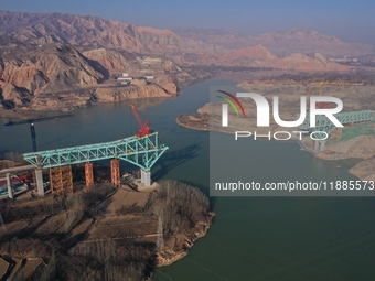 An aerial photo shows the construction of the Jianzha Yellow River Bridge, a key project of the Sichuan-Qinghai Railway in Jianzha County, Q...