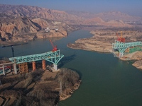 An aerial photo shows the construction of the Jianzha Yellow River Bridge, a key project of the Sichuan-Qinghai Railway in Jianzha County, Q...