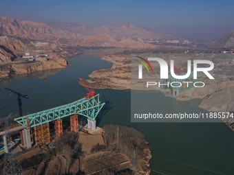 An aerial photo shows the construction of the Jianzha Yellow River Bridge, a key project of the Sichuan-Qinghai Railway in Jianzha County, Q...