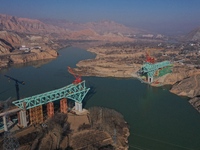 An aerial photo shows the construction of the Jianzha Yellow River Bridge, a key project of the Sichuan-Qinghai Railway in Jianzha County, Q...