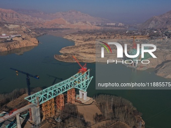 An aerial photo shows the construction of the Jianzha Yellow River Bridge, a key project of the Sichuan-Qinghai Railway in Jianzha County, Q...