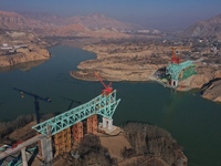 An aerial photo shows the construction of the Jianzha Yellow River Bridge, a key project of the Sichuan-Qinghai Railway in Jianzha County, Q...