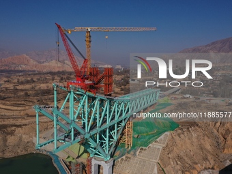 An aerial photo shows the construction of the Jianzha Yellow River Bridge, a key project of the Sichuan-Qinghai Railway in Jianzha County, Q...