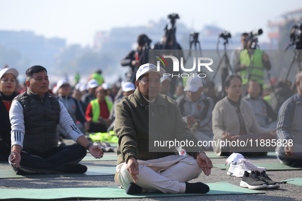 Nepal's former Home Minister Narayan Kaji Shrestha (center) attends a meditation event organized on the occasion of the first World Meditati...