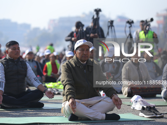 Nepal's former Home Minister Narayan Kaji Shrestha (center) attends a meditation event organized on the occasion of the first World Meditati...