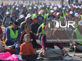 People meditate during a celebratory event organized on the occasion of the first World Meditation Day in Kathmandu, Nepal, on December 21,...