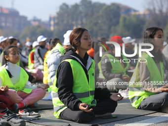 People meditate during a celebratory event organized on the occasion of the first World Meditation Day in Kathmandu, Nepal, on December 21,...