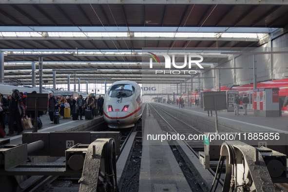 A regional train and an ICE train are at Munich Central Station in Bavaria, Germany, on December 21, 2024. Passengers get off the ICE train...