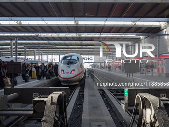 A regional train and an ICE train are at Munich Central Station in Bavaria, Germany, on December 21, 2024. Passengers get off the ICE train...