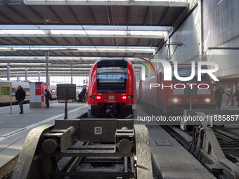 Two regional trains and an ICE are at Munich Central Station in Bavaria, Germany, on December 21, 2024. (