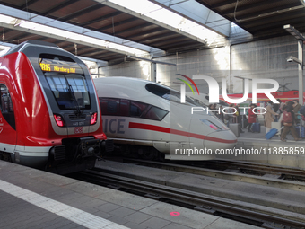 Two regional trains and two ICE trains are at Munich Central Station in Bavaria, Germany, on December 21, 2024. (