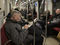 A man reads a newspaper in the metro in Warsaw, Poland, on December 21, 2024. (