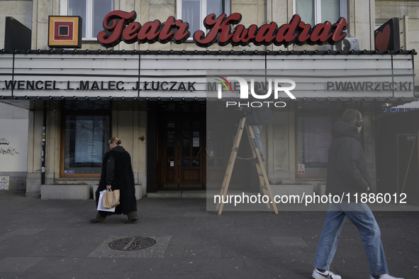 A theatre employee updates signage letters in Warsaw, Poland, on December 21, 2024. 