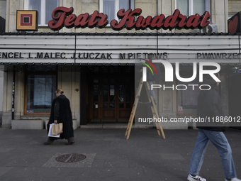 A theatre employee updates signage letters in Warsaw, Poland, on December 21, 2024. (