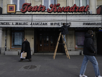 A theatre employee updates signage letters in Warsaw, Poland, on December 21, 2024. (