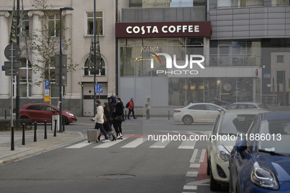 People walk past a Costa Coffee in Warsaw, Poland, on December 21, 2024. 