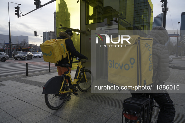 Glovo couriers are seen in Warsaw, Poland, on December 21, 2024. 