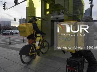 Glovo couriers are seen in Warsaw, Poland, on December 21, 2024. (