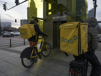 Glovo couriers are seen in Warsaw, Poland, on December 21, 2024. (