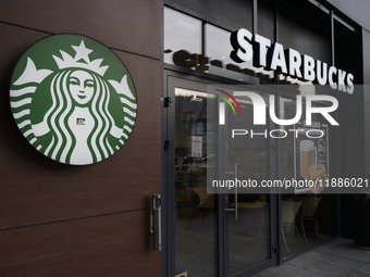 The Starbucks logo and signage are pictured in Warsaw, Poland, on December 21, 2024. (