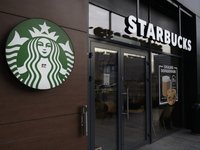 The Starbucks logo and signage are pictured in Warsaw, Poland, on December 21, 2024. (