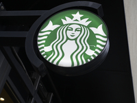 The Starbucks logo and signage are pictured in Warsaw, Poland, on December 21, 2024. (