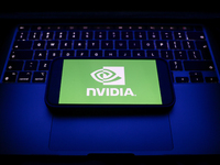 A laptop keyboard and Nvidia logo displayed on a smartphone are seen in this illustration photo taken in Krakow, Poland on December 21, 2024...