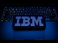 A laptop keyboard and IBM logo displayed on a smartphone are seen in this illustration photo taken in Krakow, Poland on December 21, 2024. (