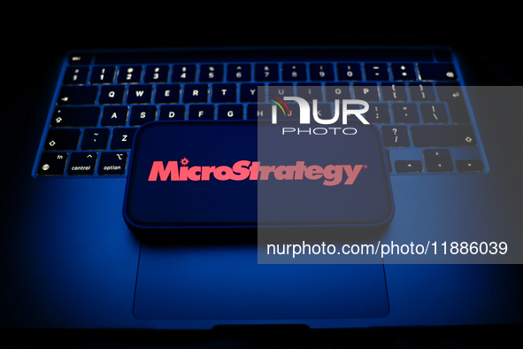 A laptop keyboard and MicroStrategy logo displayed on a smartphone are seen in this illustration photo taken in Krakow, Poland on December 2...