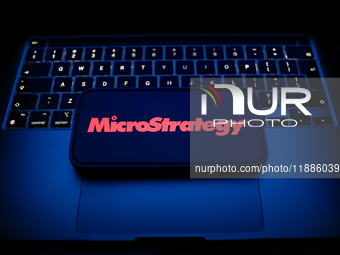 A laptop keyboard and MicroStrategy logo displayed on a smartphone are seen in this illustration photo taken in Krakow, Poland on December 2...