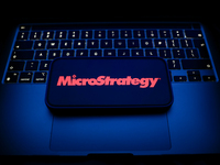 A laptop keyboard and MicroStrategy logo displayed on a smartphone are seen in this illustration photo taken in Krakow, Poland on December 2...