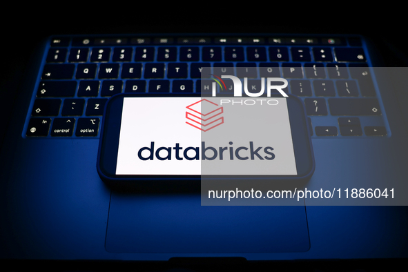 A laptop keyboard and Satabricks logo displayed on a smartphone are seen in this illustration photo taken in Krakow, Poland on December 21,...