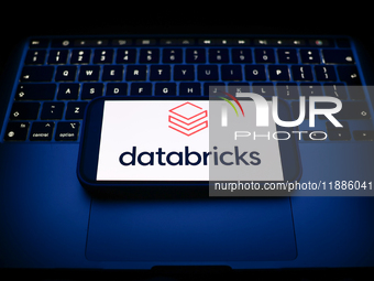 A laptop keyboard and Satabricks logo displayed on a smartphone are seen in this illustration photo taken in Krakow, Poland on December 21,...