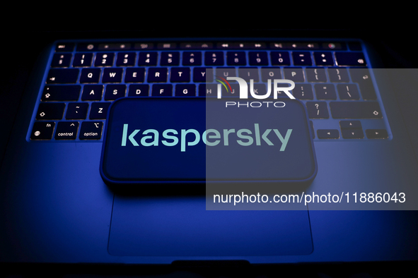 A laptop keyboard and Kaspersky logo displayed on a smartphone are seen in this illustration photo taken in Krakow, Poland on December 21, 2...