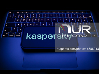 A laptop keyboard and Kaspersky logo displayed on a smartphone are seen in this illustration photo taken in Krakow, Poland on December 21, 2...