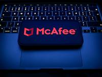 A laptop keyboard and McAfee logo displayed on a smartphone are seen in this illustration photo taken in Krakow, Poland on December 21, 2024...