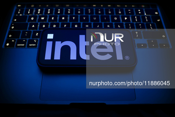 A laptop keyboard and Intel logo displayed on a smartphone are seen in this illustration photo taken in Krakow, Poland on December 21, 2024....